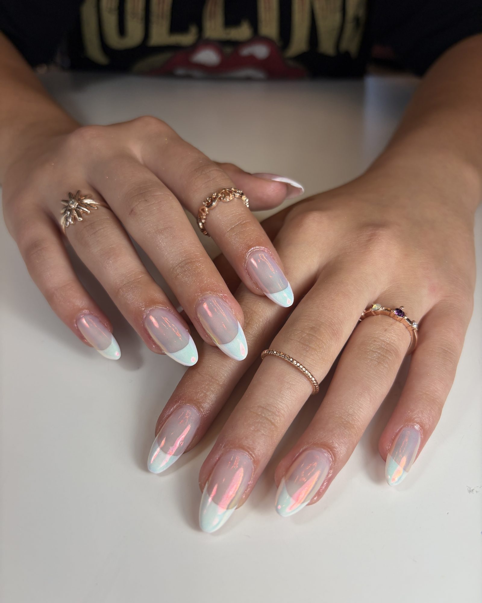 Long almond nails in an iridescent chrome with a white French tip.