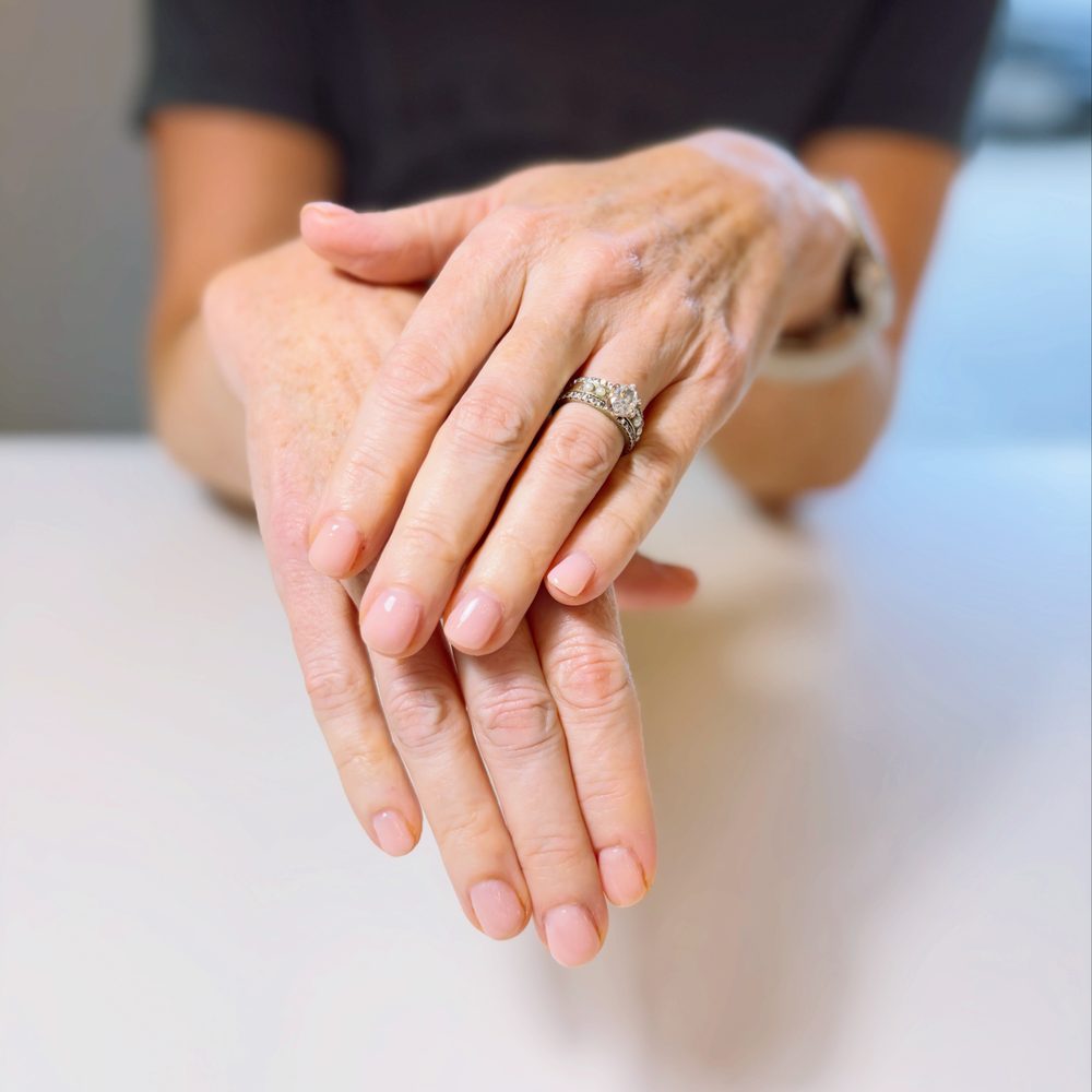 A sheer pink gel manicure on short natural nails.