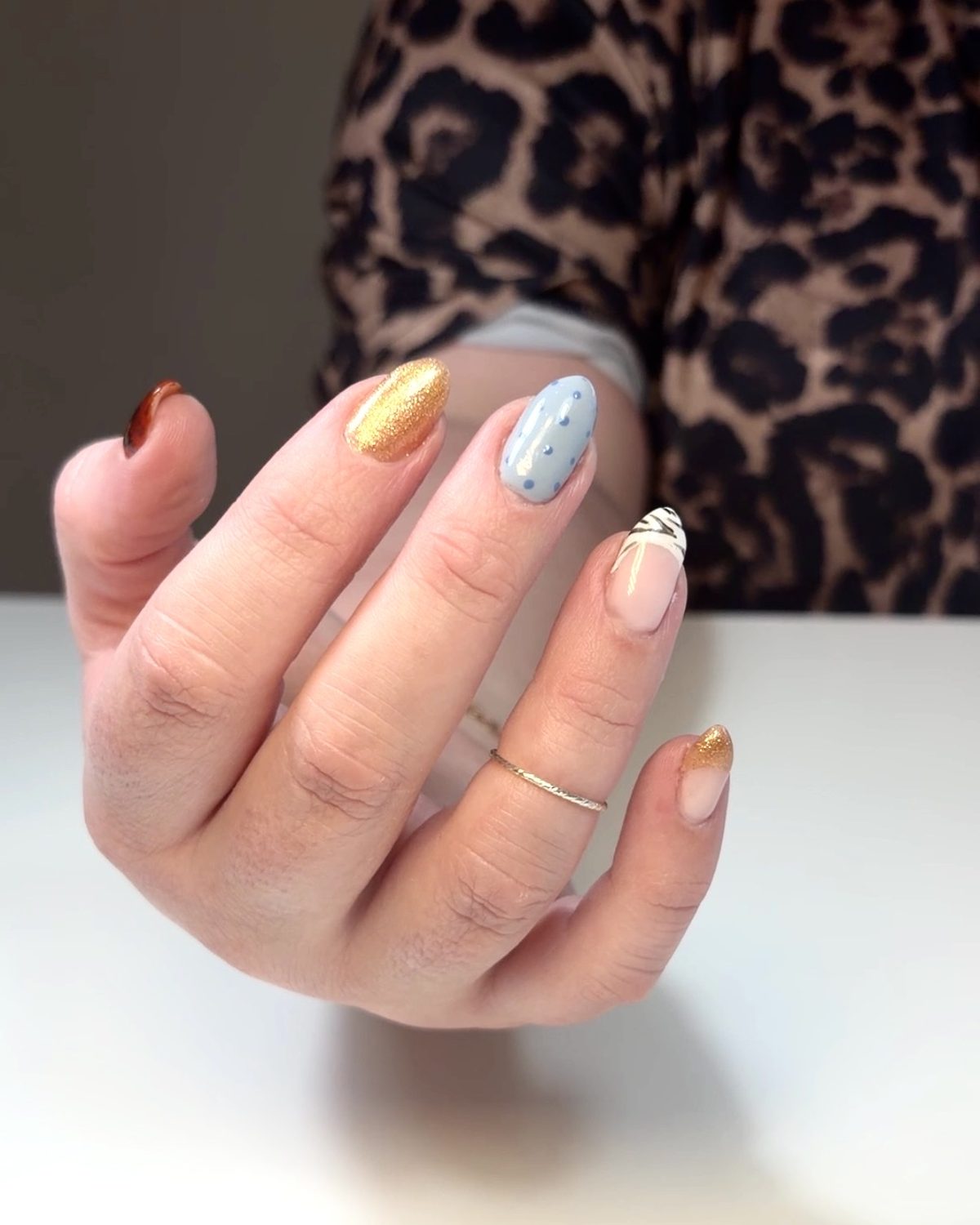 A mix-and-match set: gold glitter, blue with polka dots and a zebra-stripe tip.