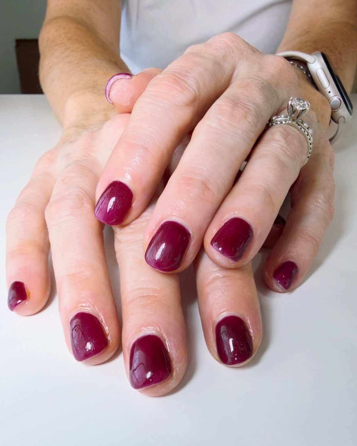 Short nails in a glossy berry red.