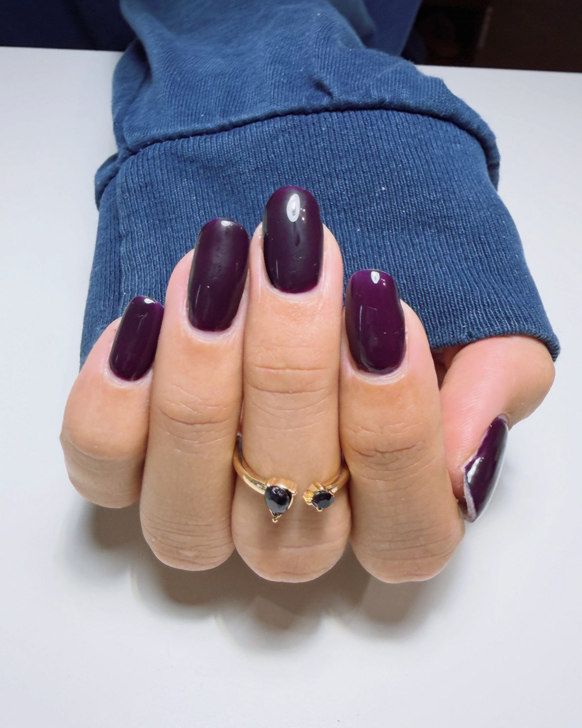 Deep plum gel on short nails.