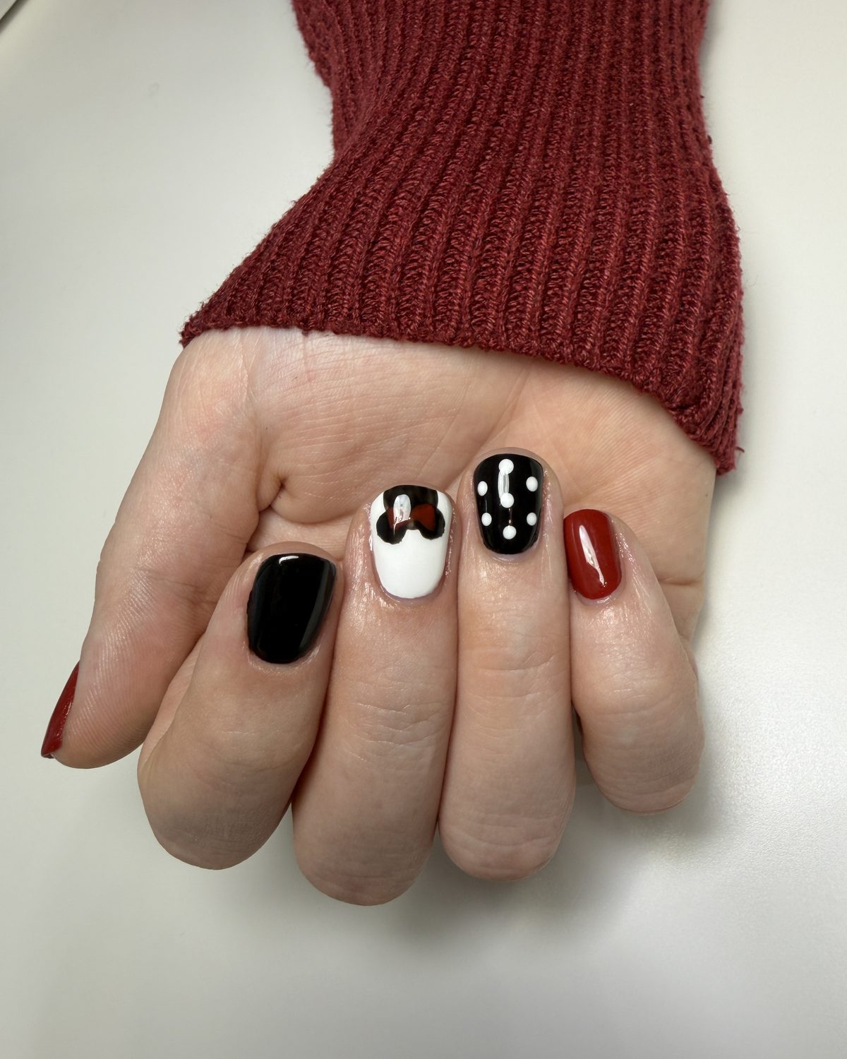 A Minnie Mouse set: black, red, white with a red bow, and white polka dots on black.